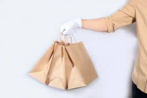 delivery person delivering food in paper bags