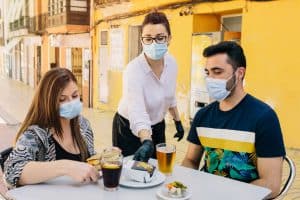 couple dining outside during cover wearing masks