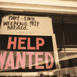 Help Wanted Sign In Window of Restaurant
