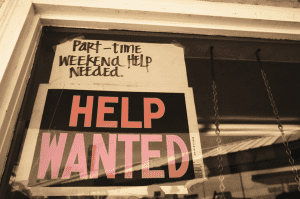 Help Wanted Sign In Window of Restaurant